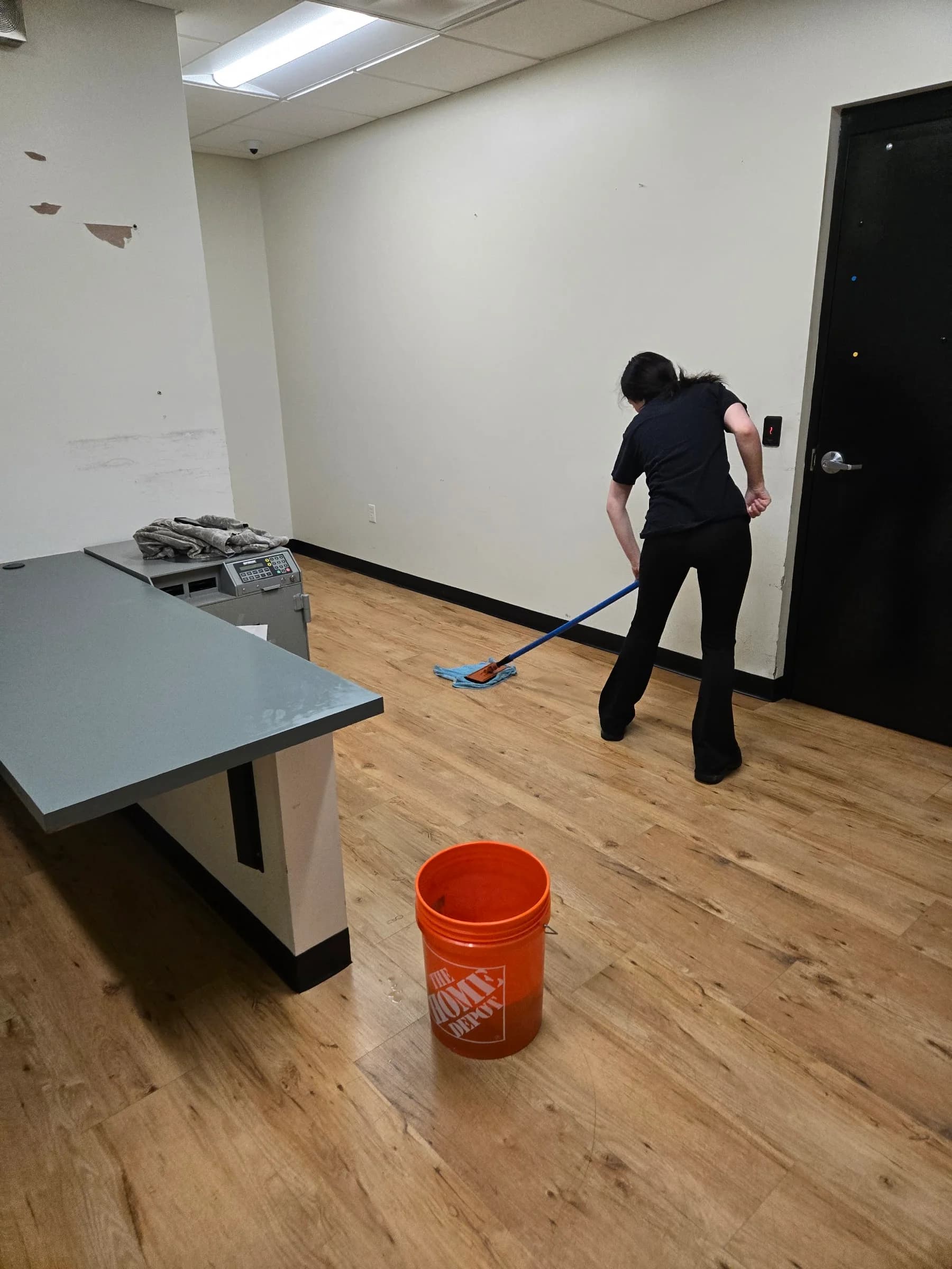 SWAT technician damp-mopping a commercial floor — SWAT Network portfolio
